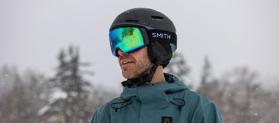 Skier wearing Smith snow helmet and goggles