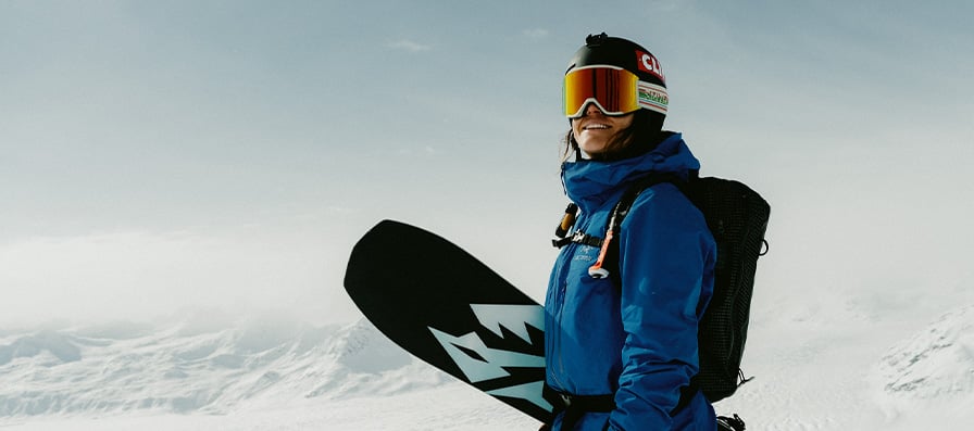 Skier wearing Smith snow helmet and goggles